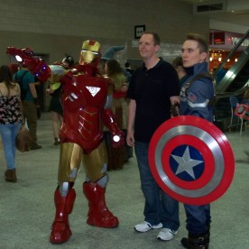 Iron Man and Captain America Cosplayers posing with another con attendee.